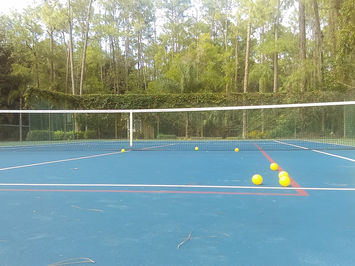 A paddle, balls and court shoes laid out before a game