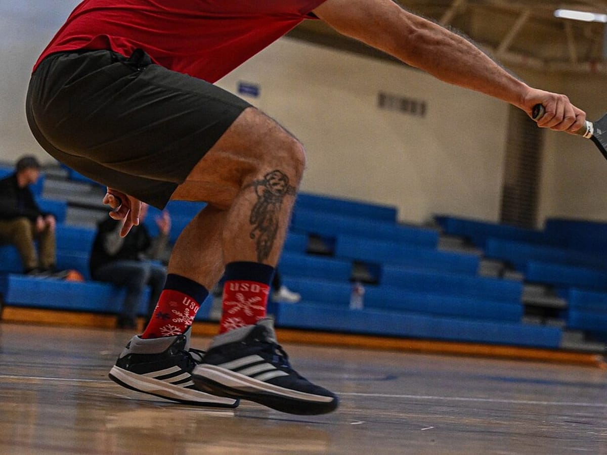 Court shoes at the baseline of a pickleball court